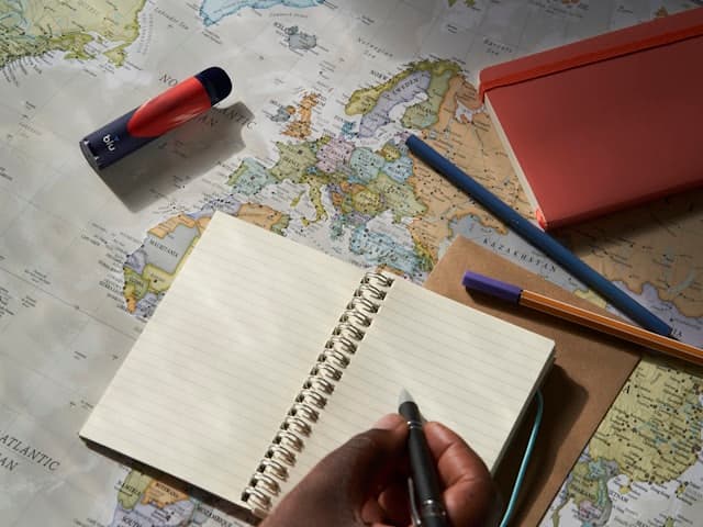 Writing in a travel notebook